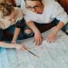 A mother and daughter plan their journey using a map, symbolizing adventure and bonding.
